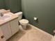 Small bathroom with a toilet, vanity, a wall-mounted mirror, and tile flooring at 5255 Memphis St # 712, Denver, CO 80239