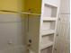 Bathroom shower and bathtub with built in shelving and a shower head at 5255 Memphis St # 712, Denver, CO 80239