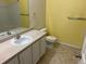 Bright bathroom featuring a single sink vanity, toilet, and bathtub with tile surround at 5255 Memphis St # 712, Denver, CO 80239