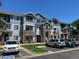 Three-story condo building features stone accents, blue siding, multiple balconies and convenient parking at 5255 Memphis St # 712, Denver, CO 80239