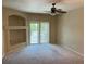 Neutral living room with a ceiling fan, a sliding glass door to a balcony, and a decorative alcove at 5255 Memphis St # 712, Denver, CO 80239