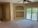 Neutral living room with a ceiling fan, a sliding glass door to a balcony, and a decorative alcove at 5255 Memphis St # 712, Denver, CO 80239
