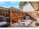 Small backyard with wooden fence and AC unit at 1557 S Owens St # 59, Denver, CO 80232