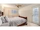 Bedroom with ceiling fan, door to exterior, and dresser at 12430 E Pacific Cir # B, Aurora, CO 80014