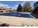 Community pool with a dark blue cover, located near brick-walled housing units and green trees at 12430 E Pacific Cir # B, Aurora, CO 80014