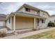 Charming two-story townhome with beige siding, covered porch, and low-maintenance front yard landscaping at 12430 E Pacific Cir # B, Aurora, CO 80014