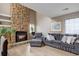 Inviting living room with a stone fireplace, plush seating, and modern décor, creating a cozy and stylish atmosphere at 12430 E Pacific Cir # B, Aurora, CO 80014