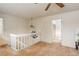 Lofted area has neutral carpet with a decorative lighting fixture at 12430 E Pacific Cir # B, Aurora, CO 80014