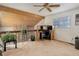 Lofted home office has natural light, ceiling fan, and stone accent wall at 12430 E Pacific Cir # B, Aurora, CO 80014