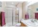 Well-lit bathroom with a glass-enclosed shower, tile surround, and a single sink vanity at 1160 S Sherman St, Denver, CO 80210