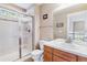 Bathroom with glass enclosed shower, wood vanity with tile countertop, toilet, and mirror at 1160 S Sherman St, Denver, CO 80210
