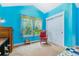 Bright bedroom with blue walls, a window with patterned curtains, and closet with sliding doors at 1160 S Sherman St, Denver, CO 80210
