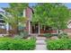 Charming brick home with mature landscaping, a well-manicured lawn, and a inviting front porch at 1160 S Sherman St, Denver, CO 80210