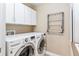 Laundry room featuring a white washer and dryer, white cabinets, and a folding rack at 1160 S Sherman St, Denver, CO 80210