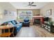 Comfortable living room featuring hardwood floors, a fireplace, ceiling fan, blue sofa and matching arm chair at 1160 S Sherman St, Denver, CO 80210