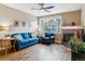 Cozy living room featuring hardwood floors, a fireplace, a ceiling fan and a blue sofa and chair set at 1160 S Sherman St, Denver, CO 80210
