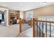 Open loft space featuring a built-in desk area and staircase with decorative wrought iron railing at 1160 S Sherman St, Denver, CO 80210