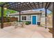Cozy patio with pergola, outdoor furniture, hammock, flowers, and blue door at 1160 S Sherman St, Denver, CO 80210