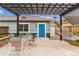 Cozy patio featuring pergola, outdoor furniture, hammock, flowers, and blue door at 1160 S Sherman St, Denver, CO 80210