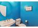Stylish powder room with striking blue walls, a pedestal sink, and modern fixtures at 1160 S Sherman St, Denver, CO 80210