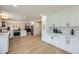 Open kitchen with white cabinetry, stainless steel appliances and seamless dining area access at 2101 Champlain Dr, Boulder, CO 80301