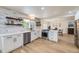 Well-lit kitchen with white cabinets, stainless steel appliances, and open layout at 2101 Champlain Dr, Boulder, CO 80301