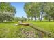 Picturesque bridge over a stream on a lush, landscaped property at 2101 Champlain Dr, Boulder, CO 80301