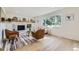 Inviting living room with a brick fireplace, hardwood floors and large picture window at 2101 Champlain Dr, Boulder, CO 80301