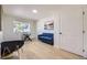 Bright room with sleek desk, blue sofa, and light wood floors at 2101 Champlain Dr, Boulder, CO 80301