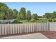 Serene backyard view featuring a white fence, lush green lawn, and mature trees at 21472 E 46Th Ave, Denver, CO 80249
