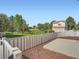 Large backyard with a white fence, green lawn, mature trees, and a view of the home at 21472 E 46Th Ave, Denver, CO 80249