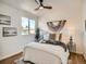 Cozy bedroom with ample natural light features a decorative ceiling fan and light wood flooring at 21472 E 46Th Ave, Denver, CO 80249