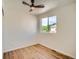 Bright bedroom featuring laminate flooring, a ceiling fan, and a sunlit window at 21472 E 46Th Ave, Denver, CO 80249