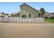 Back of the home with a well-maintained yard, white fence, and concrete patio at 21472 E 46Th Ave, Denver, CO 80249