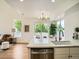 Bright kitchen view with stainless dishwasher, stone counters, and access to the outdoor patio at 21472 E 46Th Ave, Denver, CO 80249