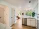 Open concept kitchen with stainless appliances and bright natural light fills the adjoining living area at 21472 E 46Th Ave, Denver, CO 80249