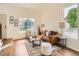 Bright living room featuring a vaulted ceiling, large windows, and hardwood flooring at 21472 E 46Th Ave, Denver, CO 80249