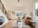 Cozy living room featuring a staircase, a large window, and hardwood flooring at 21472 E 46Th Ave, Denver, CO 80249