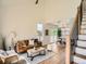 Inviting living room with high ceilings, a brown leather sofa, and open access to the dining area at 21472 E 46Th Ave, Denver, CO 80249