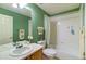 Practical bathroom with a single sink vanity, a large framed mirror, and a combined shower-bathtub at 10132 Nickolas Ave, Highlands Ranch, CO 80130