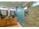 Bathroom featuring dual sinks, and an elegant shower with tiled walls and unique glass divider at 10132 Nickolas Ave, Highlands Ranch, CO 80130