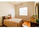 Cozy bedroom with wood floors, large windows, natural light, ceiling fan and simple neutral decor at 10132 Nickolas Ave, Highlands Ranch, CO 80130
