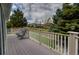 Spacious deck with white railings and comfortable outdoor seating overlooking the yard at 10132 Nickolas Ave, Highlands Ranch, CO 80130