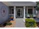Inviting front porch with a decorative trellis, potted plants, and cozy seating at 10132 Nickolas Ave, Highlands Ranch, CO 80130