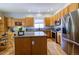 Charming kitchen featuring wood cabinets, granite countertops, stainless steel appliances and a wooden kitchen island at 10132 Nickolas Ave, Highlands Ranch, CO 80130