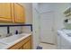 Laundry room with sink, wood cabinets, washer and dryer, with added storage space throughout at 10132 Nickolas Ave, Highlands Ranch, CO 80130
