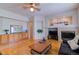 Bright living room with a fireplace, built-in cabinets, and hardwood floors at 10132 Nickolas Ave, Highlands Ranch, CO 80130