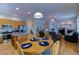 Open living space with a kitchen island, dining table, and cozy fireplace at 10132 Nickolas Ave, Highlands Ranch, CO 80130