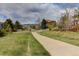 Neighborhood street with a walking path, green space, and mountain views at 10132 Nickolas Ave, Highlands Ranch, CO 80130