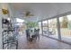 Bright sunroom with tile flooring, glass walls, and a ceiling fan at 10132 Nickolas Ave, Highlands Ranch, CO 80130